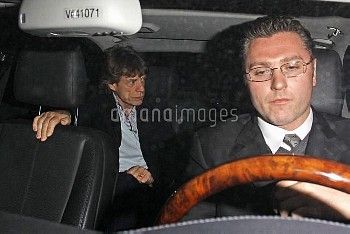 Mick Jagger and L'Wren Scott are escorted out of the back door of Matsuhisa restaurant and into waiting car - 10 February 2011