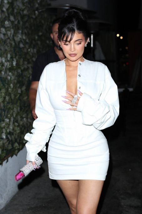 Kylie Jenner – In a white mini dress at Craig’s in Los Angeles