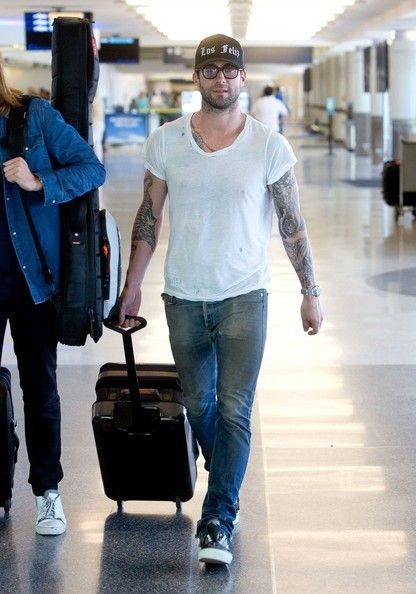 Adam Levine prepares to depart with some bandmates LAX (Los Angeles International Airport