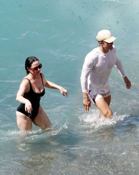 Katy Perry – Spotted in a black swimsuit while on vacation on Positano