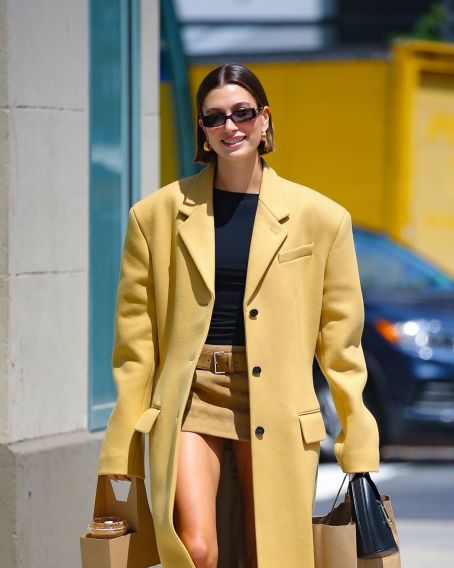 Hailey Bieber – In a yellow trench coat out in New York
