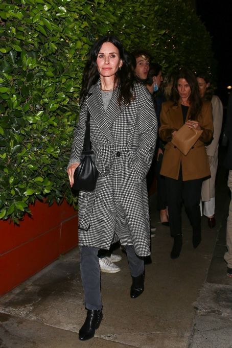 Courteney Cox – In a black and white long coat at Giorgio Baldi