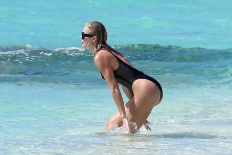 Khloe Kardashian – Spotted in a black one piece while in Turks and Caicos