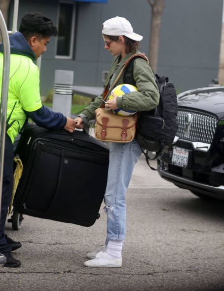 Kristen Stewart – Carries a ball as she arrives back in Los Angeles