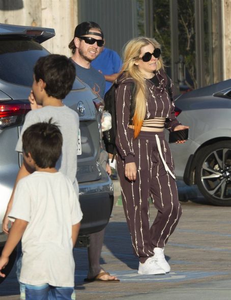 Avril Lavigne – in a bone print tracksuit seen while shopping in Malibu