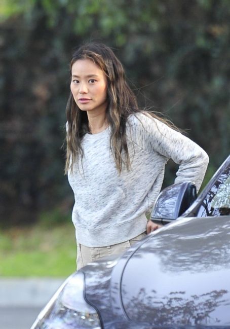 Jamie Chung – Picks up after her dog at a dog park in Los Angeles