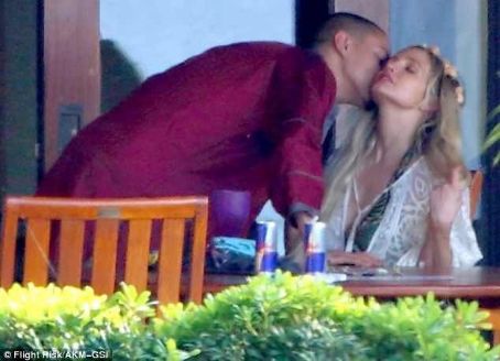 Evan Ross held onto Ashlee Simpson just moments after popping the question on Sunday january 13, 214 in Maui, Hawaii
